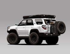 a white jeep with black tires and a roof rack