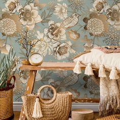 a bedroom with floral wallpaper and wicker baskets on the floor next to it