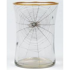 a glass vase with a spider web in the middle and gold rim around it's bottom