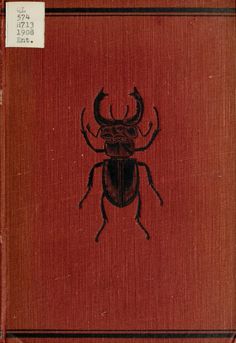 an old book with a black beetle on it's front and back cover, in red