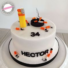 a white cake with black and orange frosting on it that reads, hector