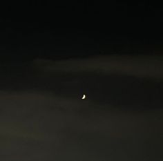 the moon is visible in the dark sky