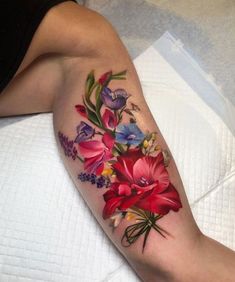 a woman's leg with flowers on it