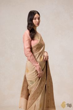 "An earthy colour and a heritage paisley motif with delicate meenakari accents. Exquisite, individually woven antique kadhua bootas on a beautiful textured bed of silk - this saree is a charming piece of handloom heritage, with love from Banaras.\u00a0\n\u00a0\n\n\n Color - A beautiful shade of Beige\n\n\n Technique\u00a0-\u00a0 An enduring Kadwa weave and fine Meenakari technique. The elaborate and laborious Kadwa (Kadhua) technique involves hand-weaving each motif separately. It takes longer on the handloom, but makes a more robust pattern, which stands out on the fabric. Meenakari involves the painstaking addition of supplementary coloured resham threads during the hand-weaving process.\n\n\n Fabric\u00a0-  Textured in appearance, pure Tussar by Georgette Silk\u00a0\n\n\n Speciality - B Festive Beige Jamawar Traditional Wear, Beige Jamawar Traditional Wear With Resham Embroidery, Traditional Beige Zari Work Blouse Piece, Ceremonial Resham Embroidered Saree, Beige Traditional Wear With Cutdana For Navratri, Beige Cutdana Traditional Wear For Navratri, Beige Traditional Wear With Chikankari Embroidery, Festive Beige Blouse Piece With Cutdana, Festive Beige Raw Silk Traditional Wear