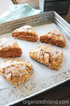 six iced cookies sitting on top of a baking sheet