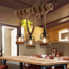 a wooden table sitting under two hanging lights