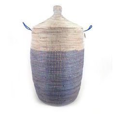 a blue and white basket with handles on the top, sitting against a white background