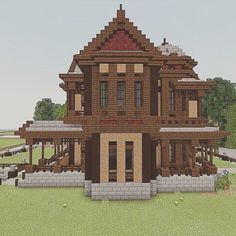 a large wooden house sitting on top of a lush green field