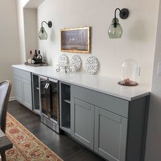 a room that has some gray cabinets on the wall and a rug in front of it