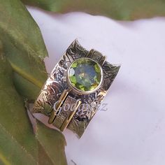 "AAA Peridot Birthstone Spinner Ring, 925 Silver Ring, Spinner Band Ring, Peridot Jewelry,Meditation Ring,Texture Designer Ring,Handmade Ring Metal : 925 Sterling Silver Weight (Gms) : 9.5 Gms Approx Style : Spinner Ring Ring Size : All Sizes Main Stone : Peridot Stone Shape : Round Stone Size : 8mm Stone Cut : Faceted Healing Properties : The Peridot crystal stone is a gem at inspiring the seekers of the universe. If it's light and love that you're after, keep this cheerful and uplifting stone Ring Texture, Peridot Birthstone, Peridot Crystal, Meditation Ring, Peridot Jewelry, Meditation Rings, Peridot Stone, Crystal Meanings, Spinner Ring