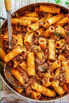 a pan filled with pasta and meat sauce