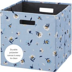 a blue fabric storage bin with flowers on it and the words durable polyster canvas is easy to clean