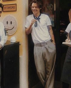 a man standing in front of a door with his hand on his hip and smiling