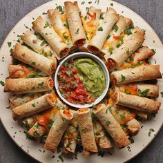 an overhead view of several appetizers on a plate with guacamole