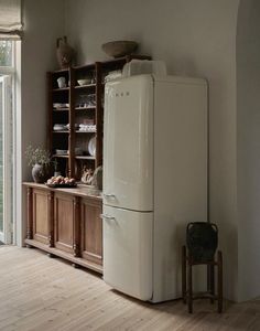 a white refrigerator freezer sitting inside of a kitchen