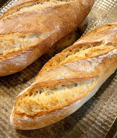 two loaves of bread sitting on top of a pan