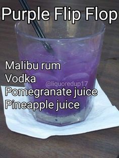 there is a purple liquid in a glass with a straw sticking out of the top