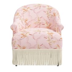 a pink chair with white fringe trim and floral print on the upholstered back