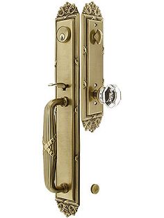 an ornate brass door handle on a white background