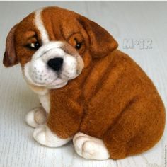 a brown and white stuffed dog laying on the floor