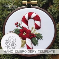 a cross stitch christmas ornament with candy cane and poinsettis on it