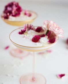 flowers in a martini glass on a white tablecloth with pink and white confetti