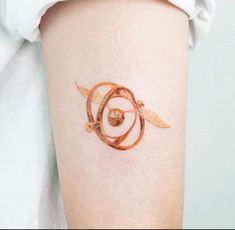 a woman's arm with a tattoo on it that looks like a spiral design