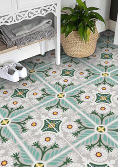 a potted plant sitting on top of a white bench next to a tiled floor