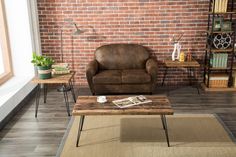 a living room filled with furniture and a brick wall behind the couch is a coffee table