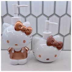 hello kitty soap dispenser and toothbrush holder in white with gold polka dots