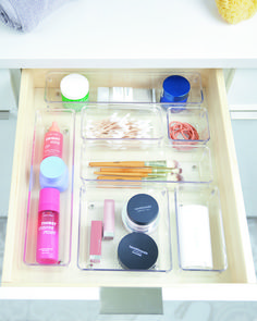 the drawers are organized with various items such as makeup, toothbrushes and other personal care products