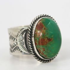 Sterling Silver Ring with Intricate Hand Stamped Designs and set with Natural Royston Turquoise from Nevada by Navajo Silversmith, Sunshine Reeves. Ring Size: 10.625” Setting Width, .875” Setting Height.5” Band Width Southwestern Multi-stone Green Jewelry, Southwestern Green Multi-stone Jewelry, Green Southwestern Style Jewelry With Inlay, Southwestern Style Green Multi-stone Jewelry, Southwestern Style Green Inlay Jewelry, Southwestern Green Cabochon Rings, Green Round Inlay Jewelry, Artisan Oval Multi-stone Turquoise Ring, Southwestern Turquoise Chrysocolla Ring