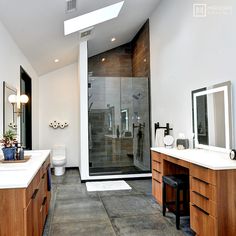 a large bathroom with two sinks and a walk in shower