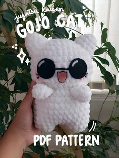 a hand holding up a small crocheted phone case that looks like an owl