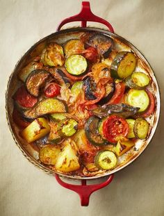 a pan filled with vegetables sitting on top of a table