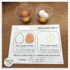 two cups with eggs in them on top of a table next to a piece of paper that says martin luther king jr