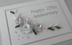 an anniversary card with flowers and leaves on it