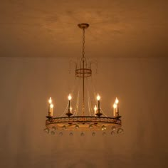 a chandelier hanging from the ceiling in a room with no one around it