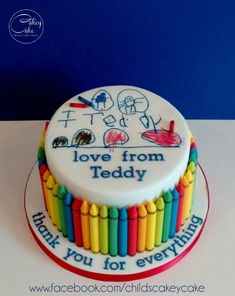 there is a cake that says love from teddy on the top and rainbow crayons on the bottom