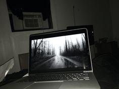 an open laptop computer sitting on top of a table