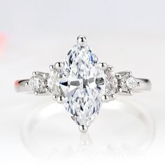 an oval cut diamond ring with three side stones