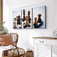 three pieces of chess are displayed on the wall next to a wicker chair and side table