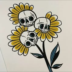 three skulls sitting on top of yellow flowers