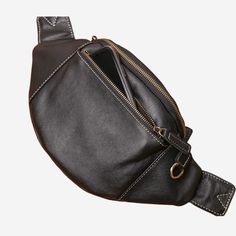 a black leather fanny bag with an open zipper on the side and a cell phone in it