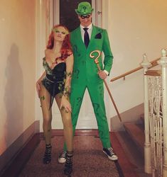 two people dressed in costumes standing on the stairs