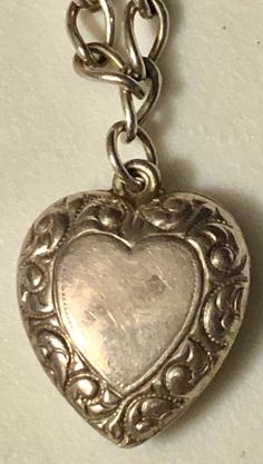 "This is a fabulous mini-collection of sterling silver hearts on a silver bracelet, ready to wear and add on if desired. You are buying FOUR puffy heart charm pendants for ONE price. They are ALL sterling silver and stamped. All of these hearts appear to be older, non-repros, dating to the early 1900s. They are on a 7\" silver (unmarked) charm bracelet and weigh a total of 8.7 grams. In very good vintage used condition, these are all sold as found, unpolished, lovely patina, all original and fre Silver Heart-shaped Nickel-free Bracelet, Silver Nickel Free Heart Bracelet, Silver Engraved Heart Bracelet For Valentine's Day, Silver Heart Bracelet With Double Heart Beads, Silver Charm Bracelet With Heart Beads, Silver Double Heart Bracelet With Heart Beads, Silver Heart Bracelet With Heart Beads, Silver Open Heart Bracelet For Valentine's Day, Silver Heart Pendant Bracelet For Anniversary