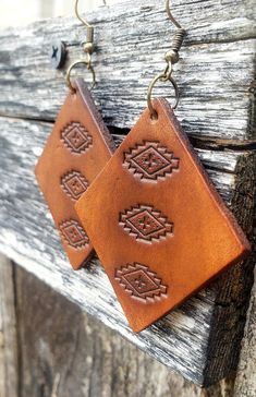 A simple Aztec design serves as the focal point for these warm, caramel leather earrings. Crafted by hand, this pair starts out as blank slates of premium veg-tanned leather and are hand-tooled and dyed for a truly unique, one-of-a-kind set.  These earrings are conditioned with beeswax, which keeps the leather supple and water resistant (see video). Edges and backs are finished, as well. Please remember that time and wear ages leather beautifully, transforming your pieces into truly personalized Adjustable Southwestern Brown Earrings, Brown Bohemian Concho Earrings, Southwestern Brown Concho Earrings, Southwestern Style Brown Concho Earrings, Hand Tooled Brown Earrings For Everyday Wear, Brown Hand Tooled Everyday Earrings, Brown Rectangular Bohemian Earrings, Bohemian Brown Rectangular Earrings, Southwestern Brown Leather Jewelry