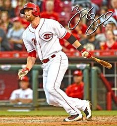 a professional baseball player is running to first base with the bat in his hand and signed autographed