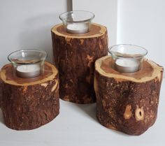 three wooden candle holders sitting on top of each other