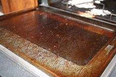 an oven door is covered in rust and dirt